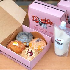 the donuts are in the pink box on the table