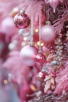 pink christmas tree with ornaments hanging from it