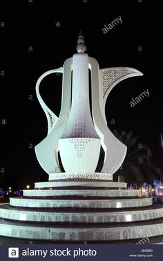 a large white sculpture in the middle of a park at night - stock image