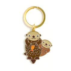 a key chain with an owl and two owls on it