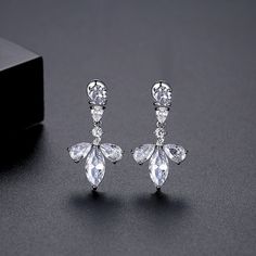 Accent your ears with the shining style of these floral stud earrings featuring cubic zirconia embellishments. 0.55" W x 1.02" L Silver-plated copper / crystal / cubic zirconia Diamond White Crystal Drop Earrings With Cubic Zirconia, Elegant Cubic Zirconia Flower-shaped Crystal Earrings, Elegant Flower Shaped Cubic Zirconia Crystal Earrings, Elegant Crystal Flower Shaped Earrings, Elegant Flower Shaped Crystal Earrings, Formal Cubic Zirconia Flower Drop Earrings, Formal Dangle Flower Earrings With Cubic Zirconia, Formal Flower Earrings With Cubic Zirconia, Cubic Zirconia Flower-shaped Earrings