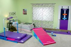 there are three exercise mats on the floor in this room, and one is purple