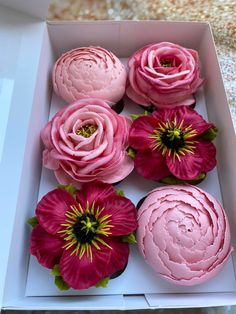 pink flowers in a white box on a table