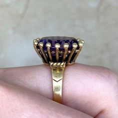 A bold vintage ring featuring an oval-cut amethyst center stone that weighs approximately 7 carats. This ring is mounted in 14k yellow gold. The center is surrounded by a halo of gold bead-shaped prongs. This ring was made in the 1970’s.
The measurements of this ring are approximately 17.82mm x 15.27mm.
The current size of this ring is 4.75 and can be resized at no extra cost.
Ready to Make It Yours? Contact us to reserve this ring and to get more info! Victorian Amethyst Ring In Yellow Gold, Antique 14k Gold Amethyst Gemstone Ring, Vintage Gold Amethyst Cabochon Ring, Victorian 14k Gold Amethyst Ring Collectible, Vintage 14k Gold Multi-stone Amethyst Ring, Oval Cut, Gold Beads, Vintage Rings, Halo