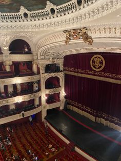 an auditorium filled with lots of red seats