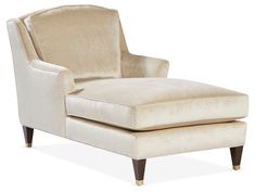 an upholstered chaise lounge chair with wooden legs