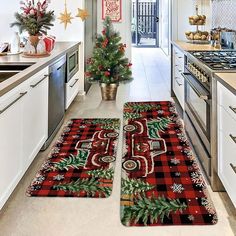 two christmas themed kitchen rugs in the middle of a kitchen with holiday decorations on them