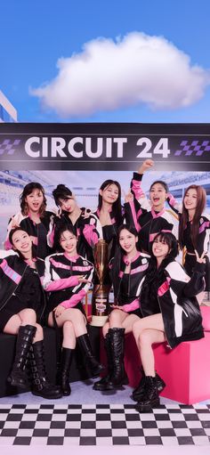 girls in black and pink outfits posing with a trophy