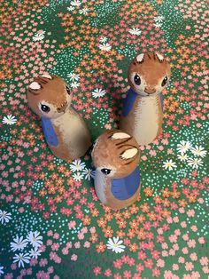 two stuffed animals sitting on top of a flower covered floor