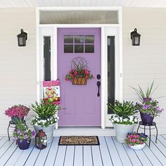 purple front door with potted flowers on the porch