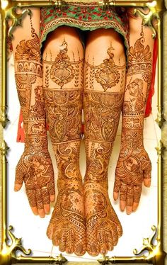 the legs and feet of a woman with henna tattoos