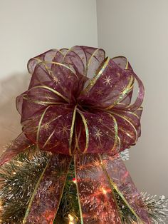 a christmas tree with a purple bow on it