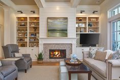 a living room filled with furniture and a fire place in front of a flat screen tv