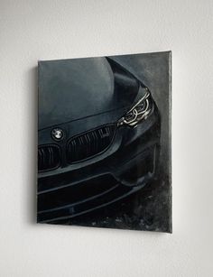 a painting of a bmw car is hanging on the wall