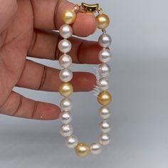 white nd gold circle south sea pearl bracelet The bracelet is made of circle south sea pearl and s925 clasp The pearl bracelet length can be customized as your size.. currently the length of the bracelet is 22cm including the clasp PRODUCT DETAIL  Material : South Sea Pearl and s925 sterling silver clasp (gold/rhodium plated) Pearl : south sea pearl Color : white nd gold Pearl size : 8.5mm -9mm Length : 20.5cm Quantity : *One strand of pearls w/ s925 setting clasp ** Chain & Clasp : s925 sterlin Luxury White Round Pearl Bracelet, White Single Strand Round Pearl Bracelet, White Single Strand Pearl Bracelet, White Akoya Pearl Round Bracelet, White Akoya Pearl Bracelet, Gold Akoya Pearl Bracelets, Gold Akoya Pearl Round Bracelet, Gold Akoya Pearl Bracelet, White Akoya Pearl Bracelets With Round Beads