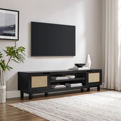 a flat screen tv mounted to the side of a wooden entertainment center in a living room