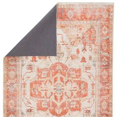 an orange and grey area rug with a gray triangle on the bottom right corner in front of it