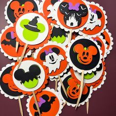 halloween cupcake toppers with mickey and minnie mouse faces on them are arranged in a circle