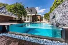 an outdoor swimming pool with water features