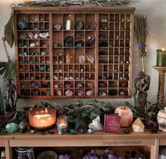 a shelf with candles, rocks and other items on it