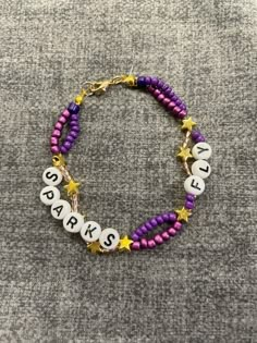 a bracelet with words and stars on it