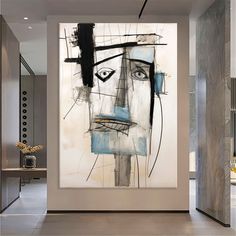 an abstract painting hangs on the wall next to a doorway in a modern style home