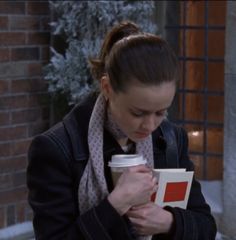 a woman holding a coffee cup in her hands