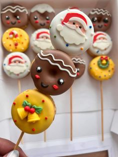 a box filled with lots of different kinds of donuts on top of wooden skewers