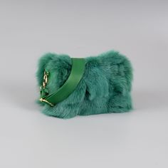 Fox fur shoulder bag with leather details in green color. This bag has a wide internal space, a detachable and adjustable strap, a zipper closure, and leather details all over. Furthermore, the green fox fur shoulder bag will stand out with its spaciousness and soft touch. The bag manufactures in our company in Greece with high-quality fox fur and leather. Fur: Fox Leather: Yes Color: Green Length: 27 cm (10,6 in) Width: 15 cm (5,9 in) Height: 15 cm (5,9 in) Lining: 100% Polyester Detachable str Green Rectangular Shoulder Bag For Winter, Luxury Faux Fur Shoulder Bag With Fur Lining, Luxury Faux Fur Shoulder Bag, Green Winter Shoulder Bag, Luxury Faux Fur Shoulder Bag For Everyday Use, Luxury Faux Fur Rectangular Shoulder Bag, Luxury Rectangular Faux Fur Shoulder Bag, Luxury Shoulder Bag With Faux Fur Lining, Fur Bag