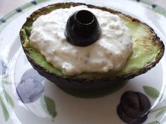 an avocado that has some kind of sauce in it and is on a plate