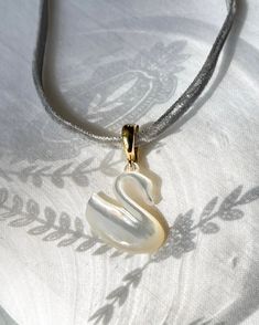 The mother of pearl Swan pendant and a grey velvet choker, making it the perfect addition to any ensemble. Take your fashion game to the next level with this timeless and chic accessory. Swan Jewelry, Swan Pendant, Swan Necklace, Velvet Choker, Swan Lake, Grey Velvet, Chic Accessories, Guinea Bissau, Wedding Necklace