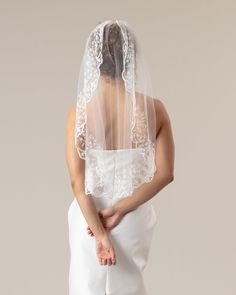 the back of a woman wearing a wedding veil