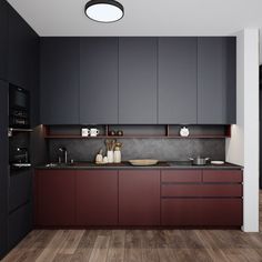 a modern kitchen with dark cabinets and wood flooring