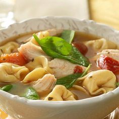 a white bowl filled with pasta and meat soup