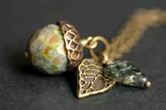 A handmade acorn necklace designed from a rainforest green glass crystal with a hint of mottled brown accents that has been combined with a detailed bronze leaf and green Czech glass leaf charm. If you would like a length of chain different than offered, please contact me for pricing. Check out the other colors if acorn necklaces offered in my shop! http://etsy.me/1iMZM8w Stop by and visit http://stumblingonsainthood.etsy.com to see more handmade designs! © Stumbling On Sainthood (StumblingOnSai Secret Message Locket, Acorn Jewelry, Oak Leaf Necklace, Acorn Pendant, Bronze Green, Acorn Necklace, Feminine Jewelry, Nature Inspired Jewelry, Leaf Charms