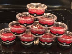 a stack of plastic cups with pokeballs on them in front of an oven