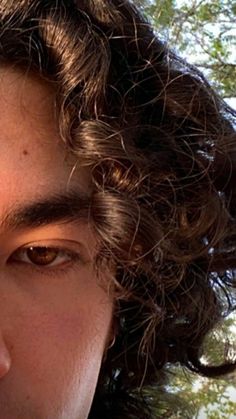 a close up of a person with curly hair