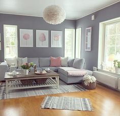 a living room filled with furniture and decor on top of a hard wood floored floor