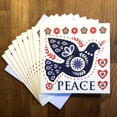 four cards with the words peace and a bird on them, sitting next to each other