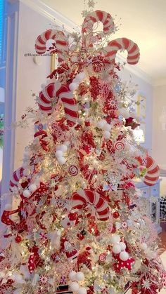 a red and white christmas tree with candy canes