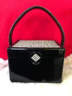 "WILARDY Lucite Handbag/Wilardy Handbags/Lucite Purse/Wilardy Purse/50's Lucite Handbag/Vintage Lucite Purse/Gorgeous MINT Condition 1955-59 Wilardy Lucite trimmed in Rhinestones This lovely is trimmed with Rhinestones on the lid, handle, and clasp. Some History of the Wilardy Handbags: Wil Hardy joined his father's company named Handbag (Metal) Specialities. Toward the end of WWII he was able to get some damaged airplane noses that were made of lucite. During that time period leather and suede Lucite Purse, Lucite Jewelry, Handbag Vintage, Metallic Purse, Top Handle Bags, Vintage Purses, Cool Lighting