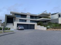 a car is parked in front of a modern house