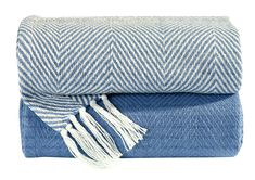 two blue and white blankets folded on top of each other, one with fringes