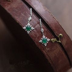 This danity green jade dangle earrings is very stunning and delicate. It's inspired by the shape of snowflake, and the vivid green jade make it unique and special among the snowflake earrings. It's a best gift idea for birthday gifts, engagement gifts, bridesmaid gifts and anniversary gifts. Features: - Made to Order - Material: 925 Sterling Silver with 14K Gold Plated - Color: White Gold - Stone: Natural Green Jade & CZ - Ready to ship in 8 to 12 business days - Each order will be beautifully packaged for gift giving in a jewelry box. Thank you for your time on our store. Hope you like our designs. Find out more about us on: https://www.etsy.com/hk-en/shop/SusannaJewelryDesignReturn and Refund: We don't accept return and refund for solid gold orders and custom orders except for quality pr Luxury Silver Jade Earrings, Fine Jewelry Green Drop Earrings, Green Fine Jewelry Drop Earrings, Elegant Jade Dangle Earrings, Green Fine Jewelry Earrings For Party, Elegant Green Gemstone Chandelier Earrings, Elegant Green Gemstone Earrings, Elegant Single Jade Earring, Green Dangle Earrings For Formal Occasions