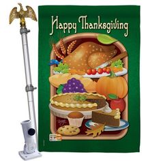 a happy thanksgiving banner with a turkey and other food items on the front, hanging from a gold frame