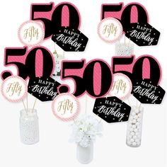 happy 50th birthday decorations in pink and black with white flowers on the top, surrounded by 50 happy birthday stickers