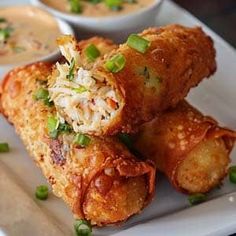 a white plate topped with fried food and dipping sauce