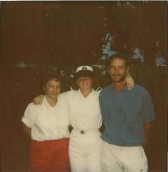 two men and a woman posing for a photo