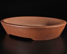 a brown bowl sitting on top of a black table