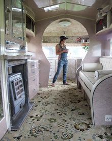 a woman standing in the doorway of a bus looking at something on her cell phone